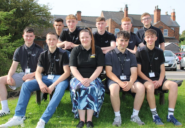 Apprentice cohort sat together on a bench ahead of national apprentice week.