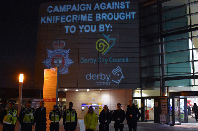 People standing in front of display at Royal Derby Hospital: Campaign against knifecrime brought to you by Derbyshire Constabulary, Derby City Council and Derby Homes